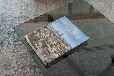 a book sitting on top of a glass table at WealthyStays 360 Luxury Residence in Nicosia