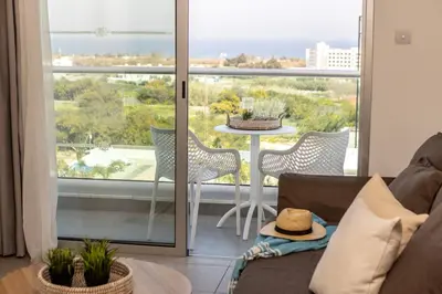 a living room with a couch and a table at Somantonia apartments in Protaras
