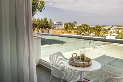 a table and chairs on a balcony with a view at Somantonia apartments in Protaras
