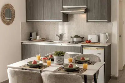 a kitchen with a table with fruit on it at Somantonia apartments in Protaras