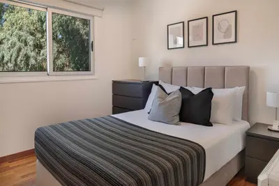 a bedroom with a large bed and a window at Phaedrus Living Evergreen Nicosia City Residence in Nicosia