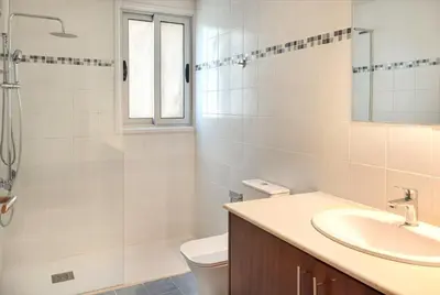 a white bathroom with a sink and a toilet at Phaedrus Living Evergreen Nicosia City Residence in Nicosia