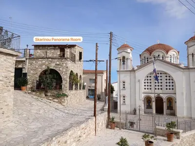a church and a building with a street at Skarinou Panorama Room in Skarinou