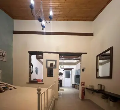 a room with a hallway with a mirror on the wall at Finikous Cottage House-Agros in Agros