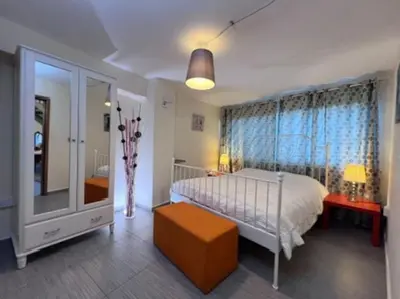 a bedroom with a bed and a large window at Finikous Cottage House-Agros in Agros