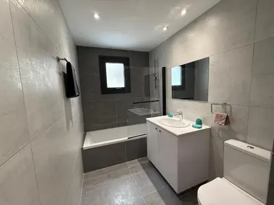 a bathroom with a sink and a toilet and a tub at Glabur Stays - Nicosia Elite 2BDR in Nicosia
