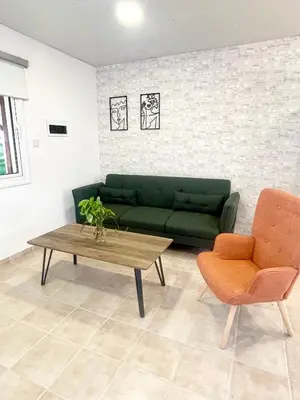 a living room with a green couch and a coffee table at Cosy Refurbished Apt City Centre in Limassol