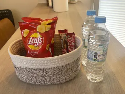 a basket with snacks and water bottles on a table at Cosy Refurbished Apt City Centre in Limassol