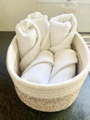 a basket filled with towels sitting on a counter at Cosy Refurbished Apt City Centre in Limassol