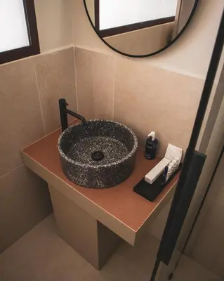 a bathroom with a stone sink on a counter at Alinea Lano Old Town Center in Limassol