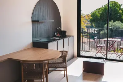 a kitchen with a table and a balcony at Alinea Lano Old Town Center in Limassol