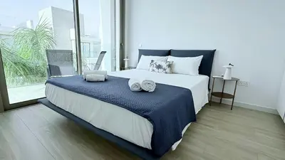 a bedroom with a large bed with two towels on it at TooCoool Villa - Azure Seaview in Protaras