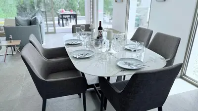 a white table with chairs and a bottle of wine at TooCoool Villa - Azure Seaview in Protaras