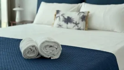 a bed with two rolled towels on top of it at TooCoool Villa - Azure Seaview in Protaras