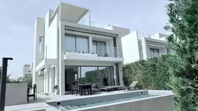 a white house with a patio and a swimming pool at TooCoool Villa - Azure Seaview in Protaras