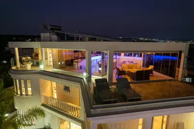 a balcony of a house at night with a living room at Royal Nissi Mansion 3 bed lower part of villa in Ayia Napa