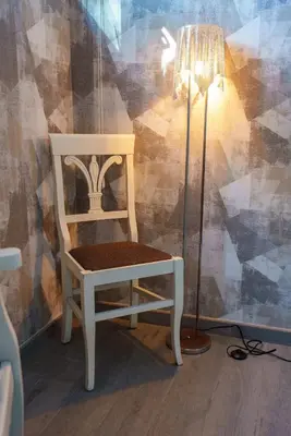 a white chair sitting next to a floor lamp at Royal Nissi Mansion 3 bed lower part of villa in Ayia Napa
