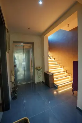 a room with a staircase with a door and a stair case at Royal Nissi Mansion 3 bed lower part of villa in Ayia Napa