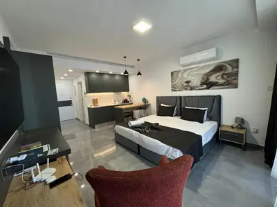 a bedroom with a bed and a desk and chairs at Courtyard Holiday Resort Studio in Iskele