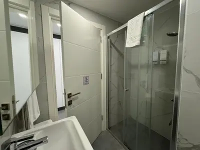 a bathroom with a shower and a sink at Courtyard Holiday Resort Studio in Iskele