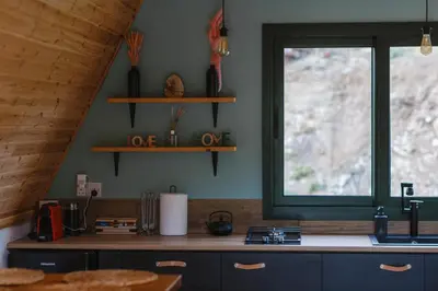 a kitchen with a sink and a window and a counter at Cozy Glamping Cabin for Couples and Families in Arakapas