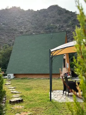 a gazebo with a table and chairs in a yard at Cozy Glamping Cabin for Couples and Families in Arakapas