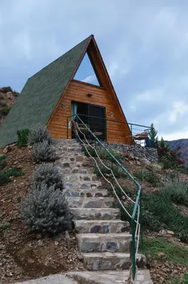 a house with stairs leading up to a building at Cozy Glamping Cabin for Couples and Families in Arakapas