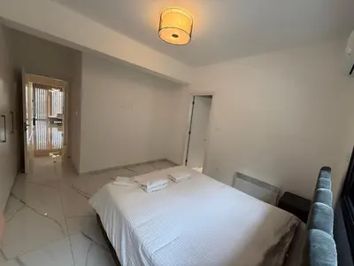 a bedroom with a white bed and a light at Glabur Stays - Nicosia's Finest 2 Bedroom in Nicosia