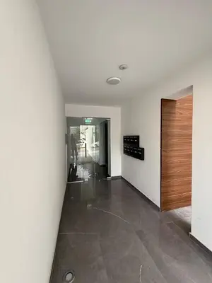 a hallway of an office building with a wooden door at Glabur Stays - Nicosia's Finest 2 Bedroom in Nicosia