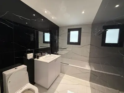 a bathroom with a white toilet and a sink at Glabur Stays - Nicosia's Finest 2 Bedroom in Nicosia