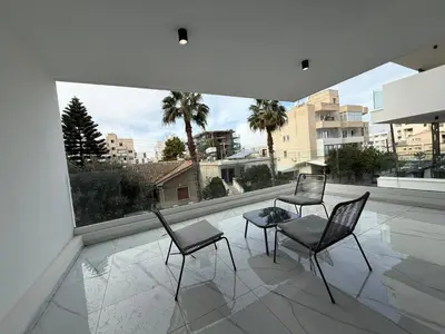 three chairs and a table on a balcony with a view at Glabur Stays - Nicosia's Finest 2 Bedroom in Nicosia