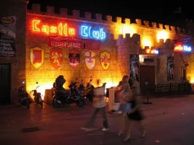 a group of people walking in front of a building at night at Ayia Napa Apartment in Ayia Napa
