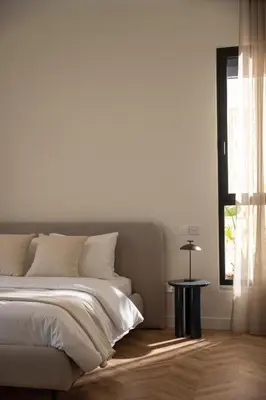 a white bedroom with a bed and a table at Interlace by Holistays in Engomi