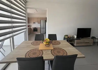 a dining room table with a bowl of fruit on it at Modern 2BR near UNIC & Engomi Mall in Lakatamia