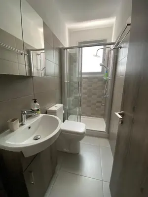a bathroom with a sink and a toilet and a shower at Modern 2BR near UNIC & Engomi Mall in Lakatamia