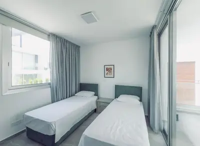 two beds in a room with a window at Imperial Jade V4 - Villa Andriana in Protaras in Protaras
