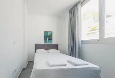 a white bedroom with a bed and a window at Imperial Jade V4 - Villa Andriana in Protaras in Protaras