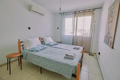 a bedroom with a bed and a window at Rosam Seaview Holiday apartment in Ayia Napa