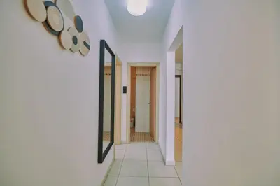 a hallway of a house with white walls and a mirror at Rosam Seaview Holiday apartment in Ayia Napa