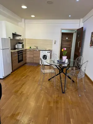 a kitchen with a table and chairs in a room at Ithaki Phinikoudes Apartment No. 205 in Larnaka