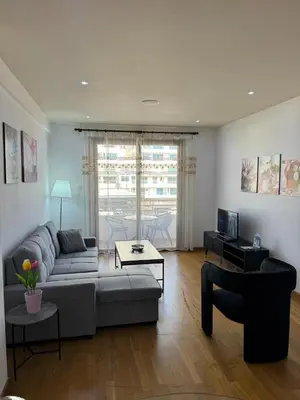a living room with a couch and a table at Ithaki Phinikoudes Apartment No. 205 in Larnaka
