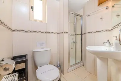 a white bathroom with a toilet and a sink at Anthorina Greco Villa #18 in Protaras