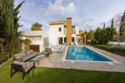 a villa with a swimming pool and a house at villa Ionion H32 in Ayia Napa
