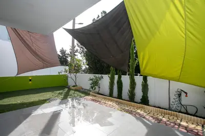 a courtyard with a building with yellow and green at Palmove Renovated Meneou House in Larnaka