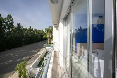 a balcony of a house with a view of a street at Palmove Renovated Meneou House in Larnaka