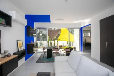 a living room with a white couch and a table at Palmove Renovated Meneou House in Larnaka