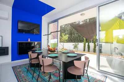 a dining room with a black table and chairs at Palmove Renovated Meneou House in Larnaka