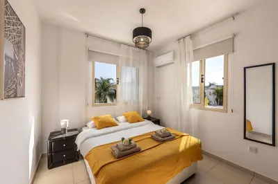a bedroom with a large bed with two towels on it at villa Palms 31 in Protaras