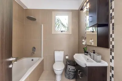 a bathroom with a toilet and a sink and a tub at Villa Palms 32 in Protaras