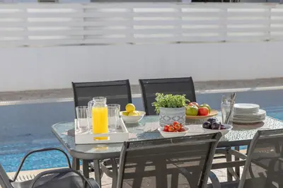 a table with a tray of fruit and juice on it at Villa Palms 32 in Protaras